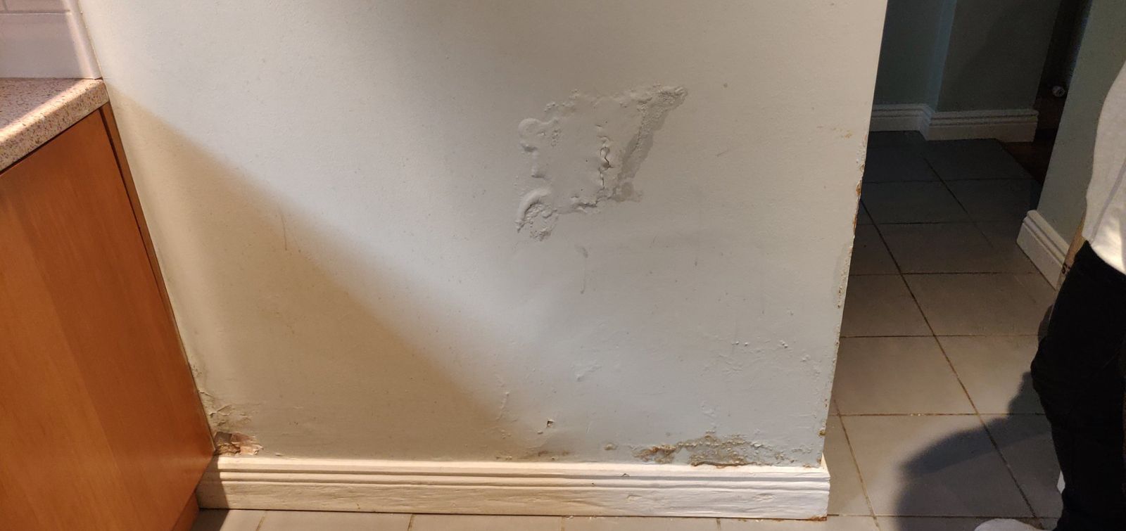 Bubbling paint and damp patch on the wall