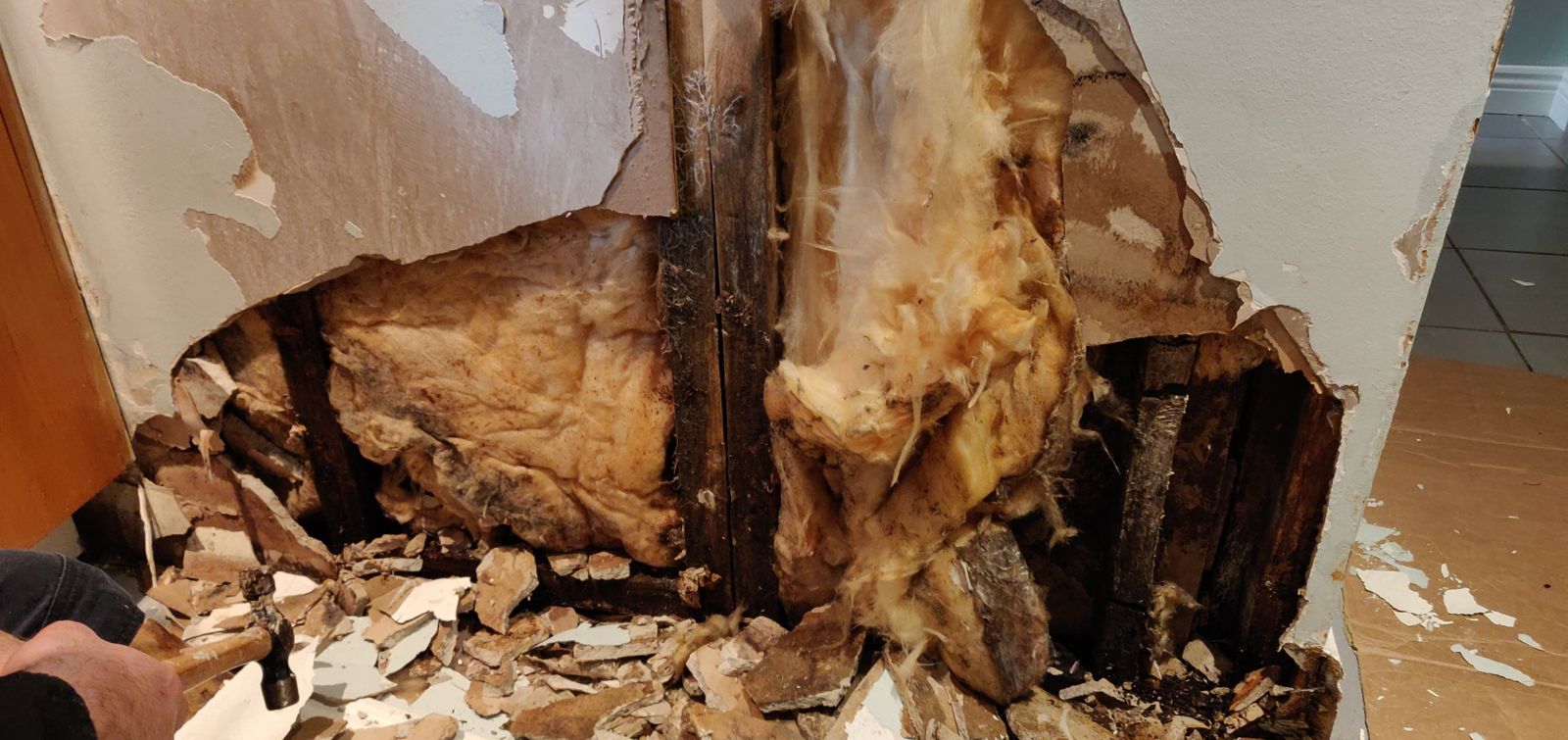 Wall opened up to find the source of a hidden shower leak