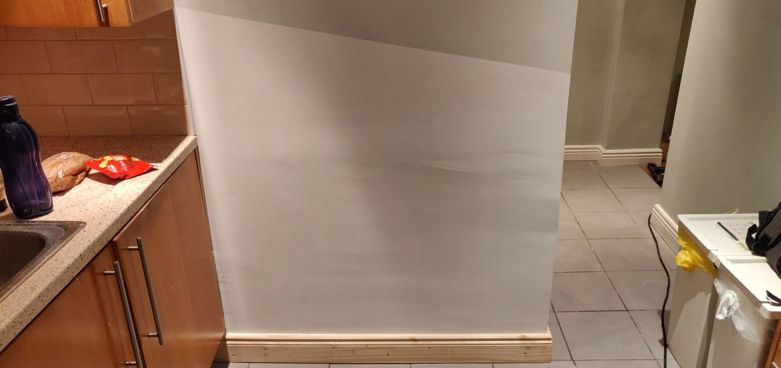 Finished wall, painted, with new skirting