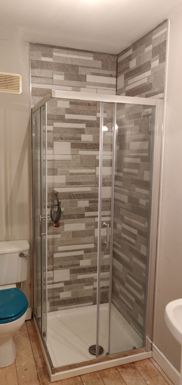 Finished shower with new sliding glass enclosure
