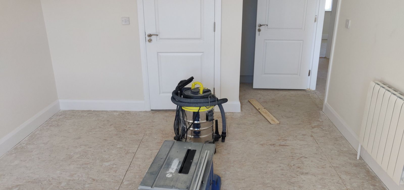 Bedroom before: bare chipboard subfloor